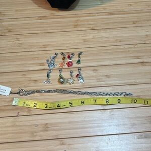 NWT silver tone necklace with 8 holiday charms/pendants.